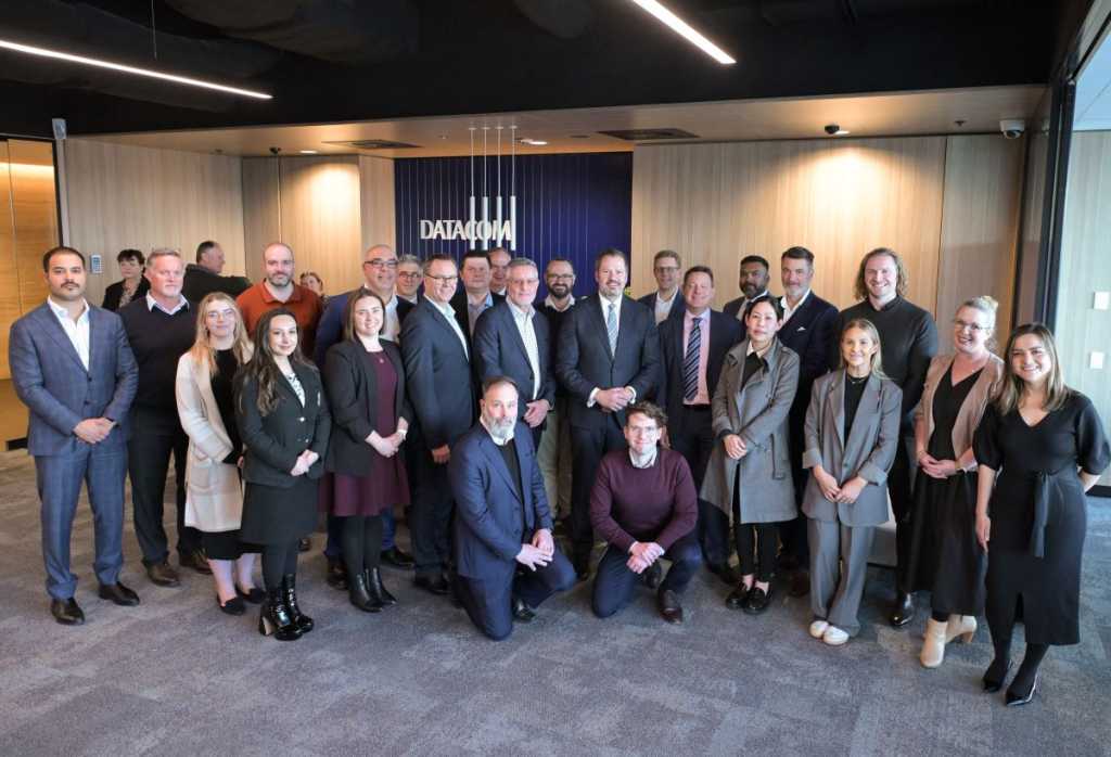 Minister Ed Husic (centre right) and the Datacom team