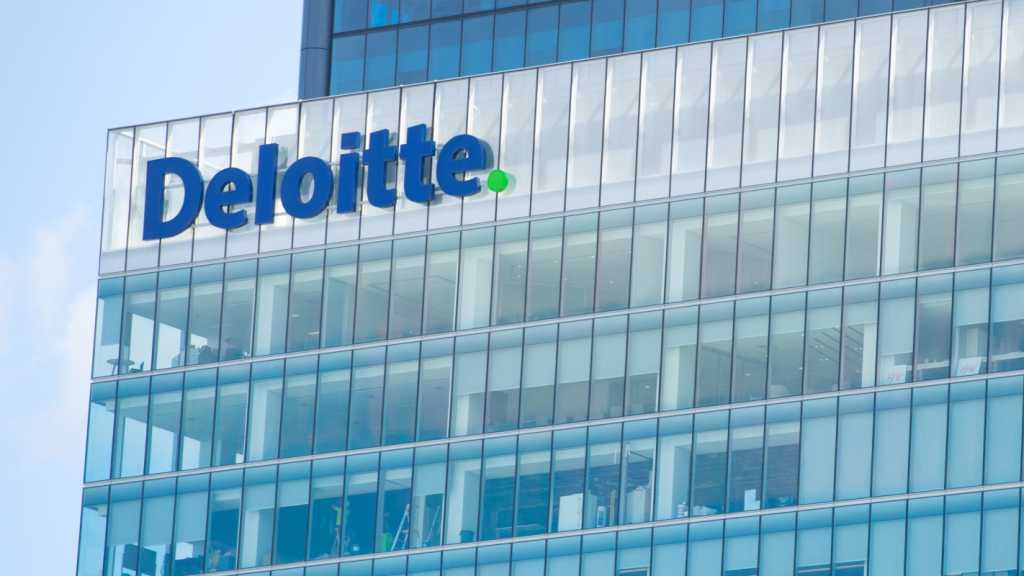 A photograph of a building with the Deloitte logo on the facade.