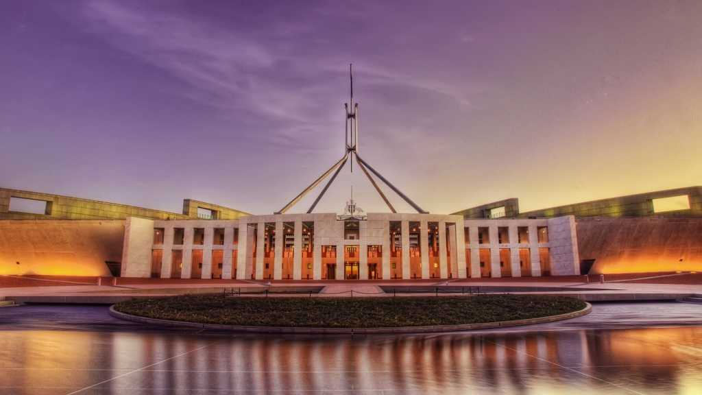 A photograph of Parliament House at sunrise.